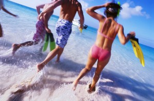 Group of Friends Running Into the Water Wearing Snorkeling Gear --- Image by © Royalty-Free/Corbis